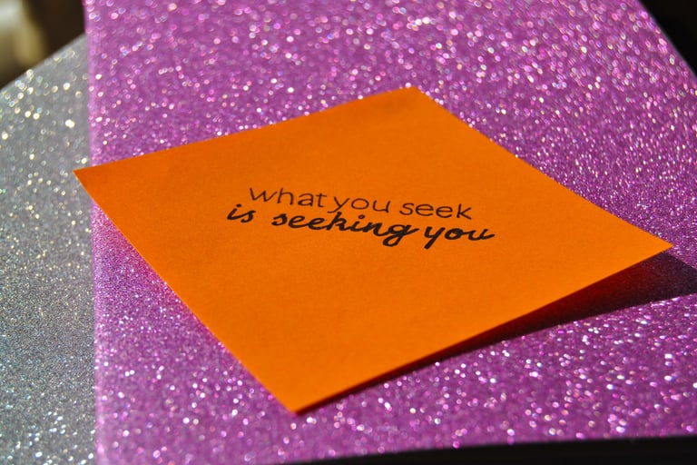 Post it reading "what you seek is seeking you"