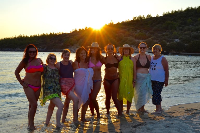 A group of women in swimwear, standing in the sea in Turkey in the afternoon sun
