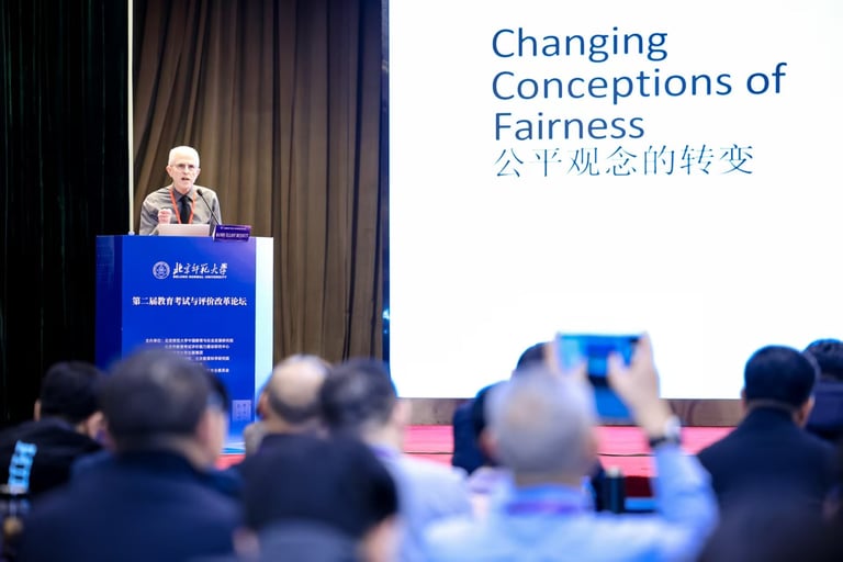 Randy Bennett at podium with slide titled "Changing Conceptions of Fairness" shown in English and Chinese