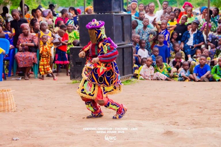 Egungun masquerade performing in colorful traditional costume at a Benin cultural festival in Dassa-Zoumé.