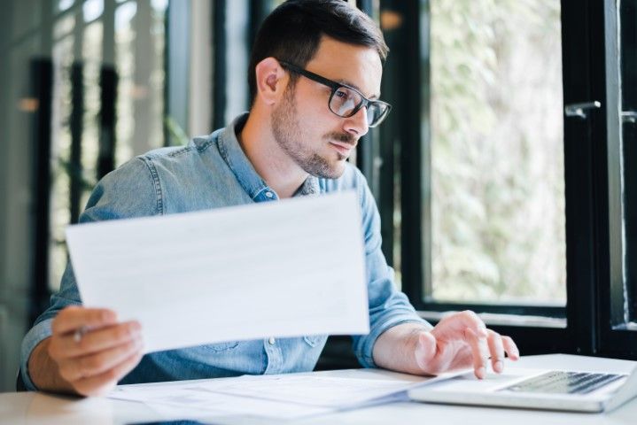 Bookkeeper reviewing financial statements on a laptop