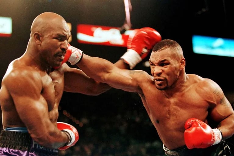 Mike Tyson lands a powerful punch on Evander Holyfield during their historic heavyweight boxing match.