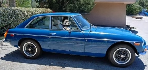 A side view of a 2 door blue MG MGB GT.