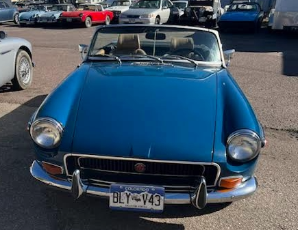 A front view of a blue MG MGB GT.