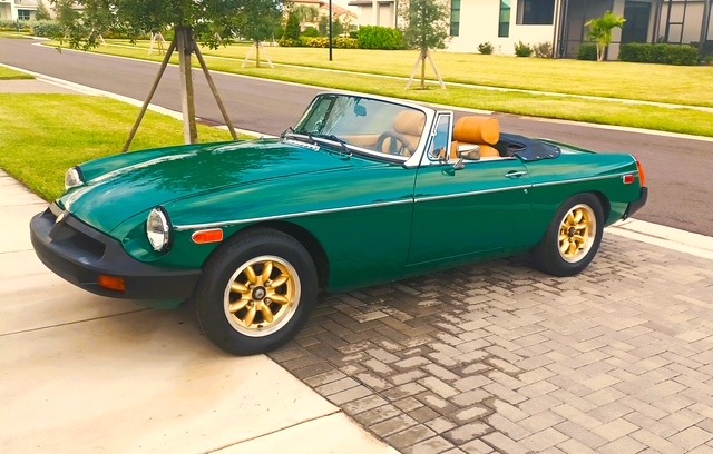 A sideview of a MG MGB roadster in British Racing Green.