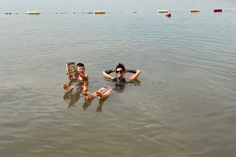 floating in the dead sea jordan with kids