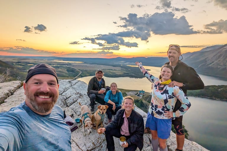 Friends and dogs at sunrise on Bear’s Hump above Upper Waterton Lake.