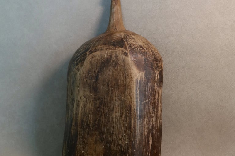 Antique hand-carved rustic wooden grain scoop with a weathered brown finish and primitive handle.
