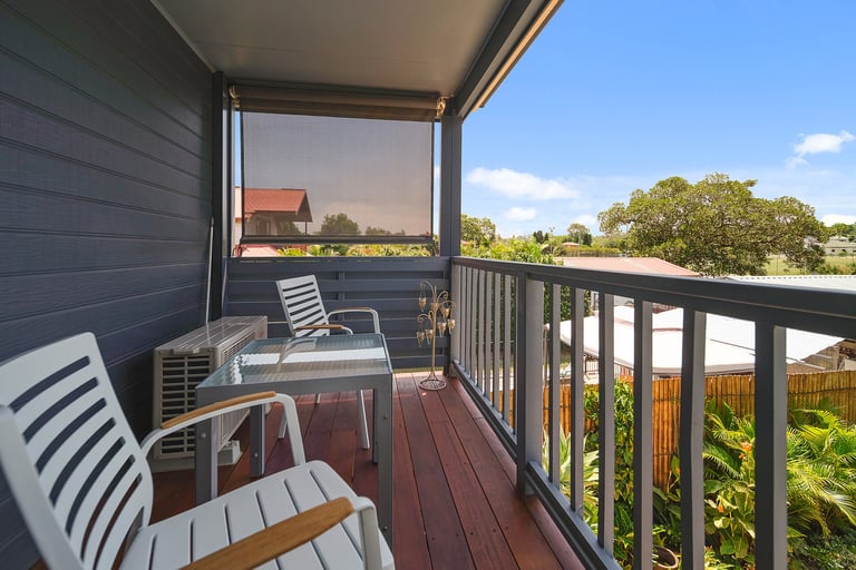 Private balcony at Marche Home Stay with cosy seating, garden views, and a peaceful outdoor space to relax.