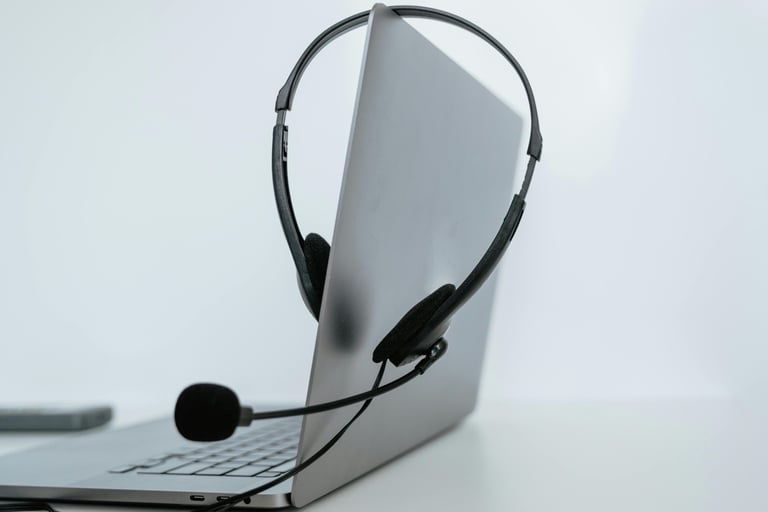 a laptop computer with a headset and a microphone