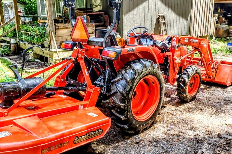 Tractor bush hogging field mower