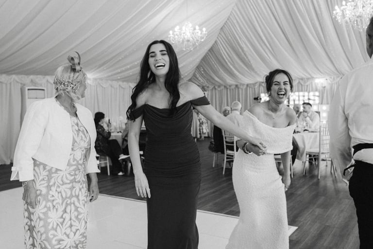 bridesmaid and guest laughing on the dancefloor at London Shenley Club