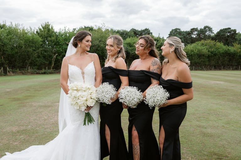 Bridesmaids gathered around the bride holding bouquets at London Shenley Club