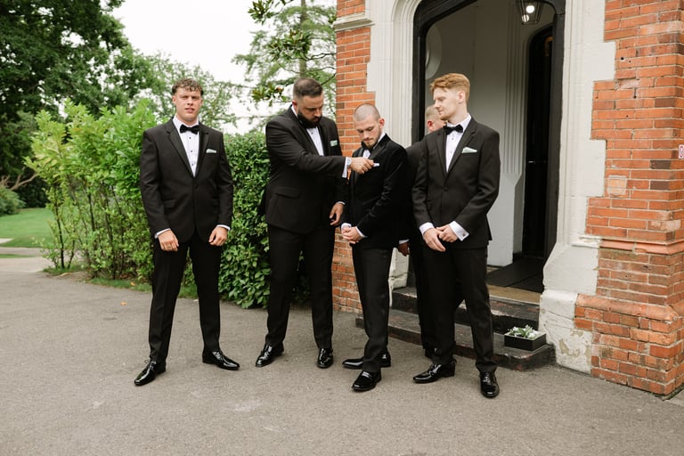 groomsmen standing in front of highley Manor