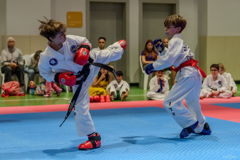 Junior Hwa Rang ITF Taekwondo students sparring at grading event in Dubai