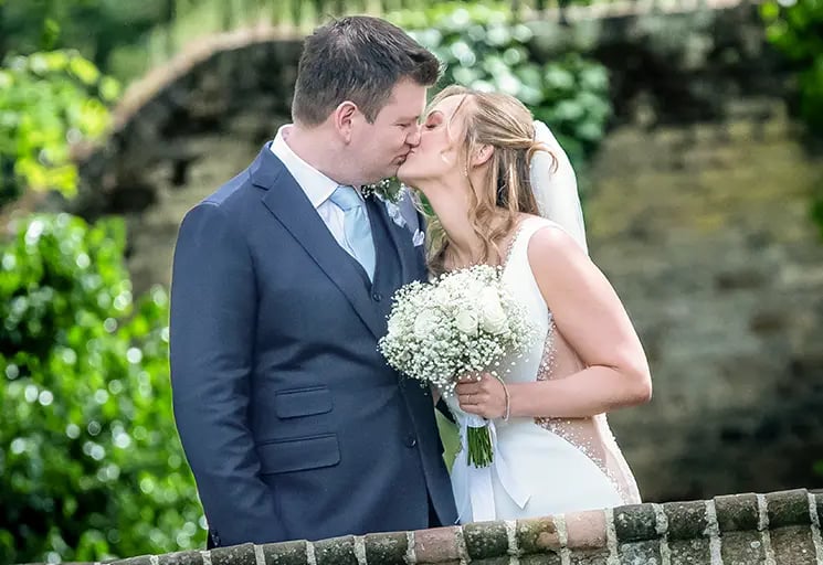 wedding couple sharing a kiss