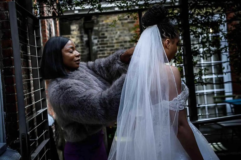 brides mother adjusting her daughters wedding veil