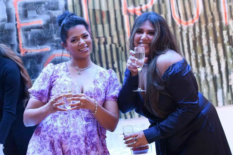 wedding guests posting with glasses of champagne