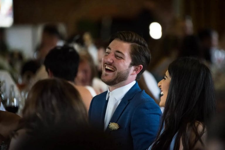 male wedding guest laughing