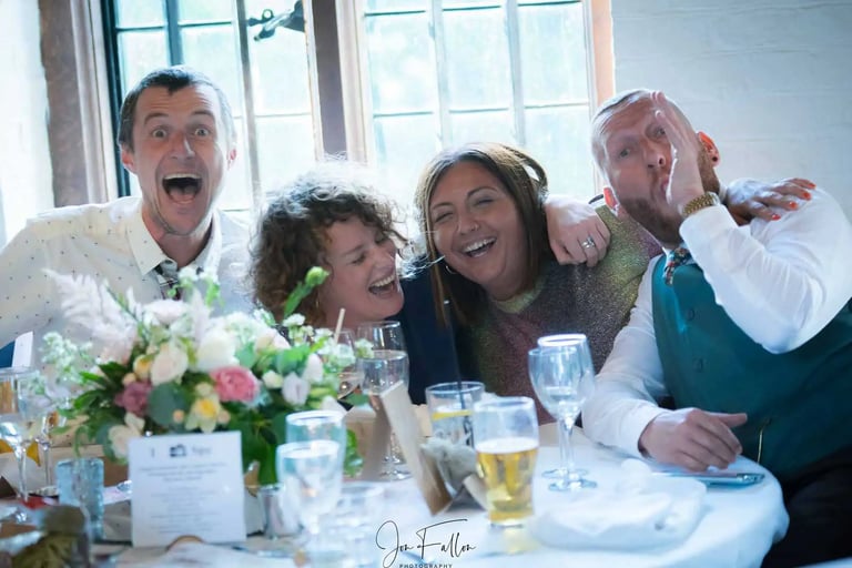 wedding guests sitting at a table havig fun