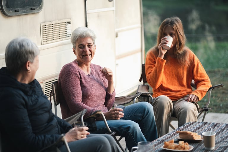Family drinking coffee and eating breakfast outside while enjoying the great outdoors at an RV Park