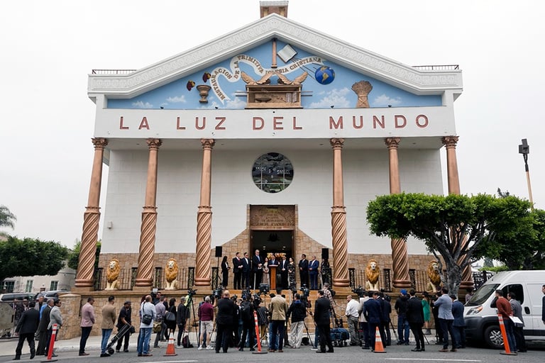 Press conference outside La Luz del Mundo temple with reporters and news cameras.