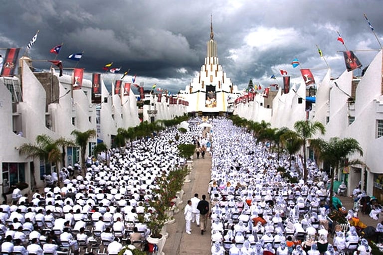 Crowd of worshippers in white at La Luz del Mundo temple in Guadalajara under cloudy skies.