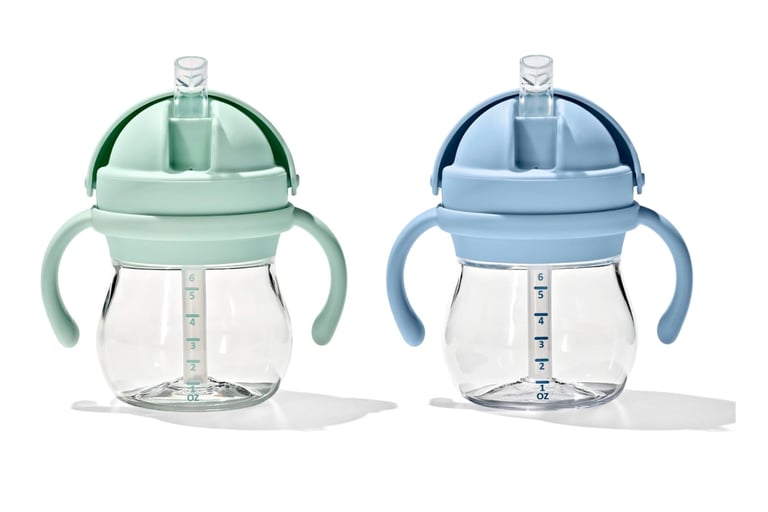 Two weighted straw sippy cups for toddlers in mint green and light blue with handles.