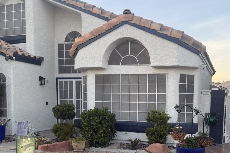 Newly painted house with numerous old colonial style solar screens