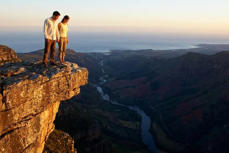 Christian dating couple standing on the edge of a cliff, about to fall in love