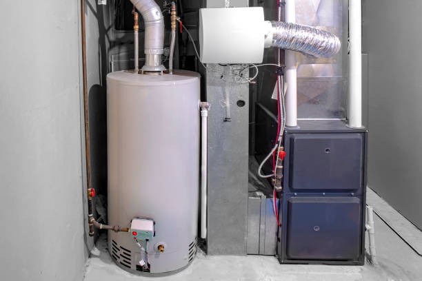 A residential natural gas water heater installed next to a high-efficiency HVAC furnace system.