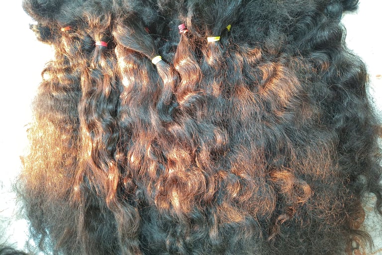 Raw human hair material being carefully segregated by texture and length at Tanori Hair LLP before the manufacturing process