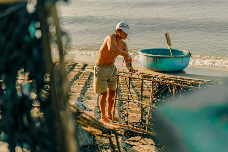 a man standing on a beach with a boat in the background