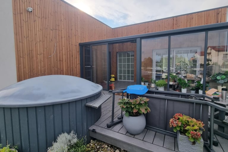 a hot tub with a blue umbrella and a blue umbrella