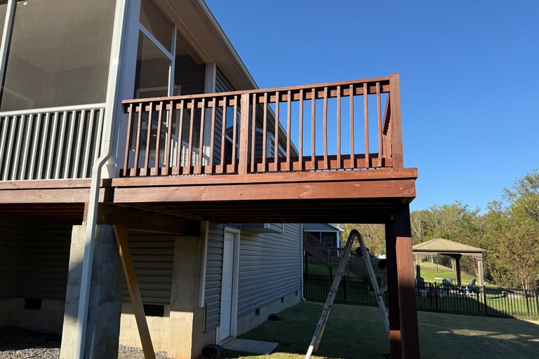 Freshly stained deck on the back of a house.