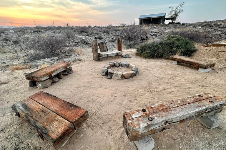 a boma with benches for a bonfire in the desert in uis namibia