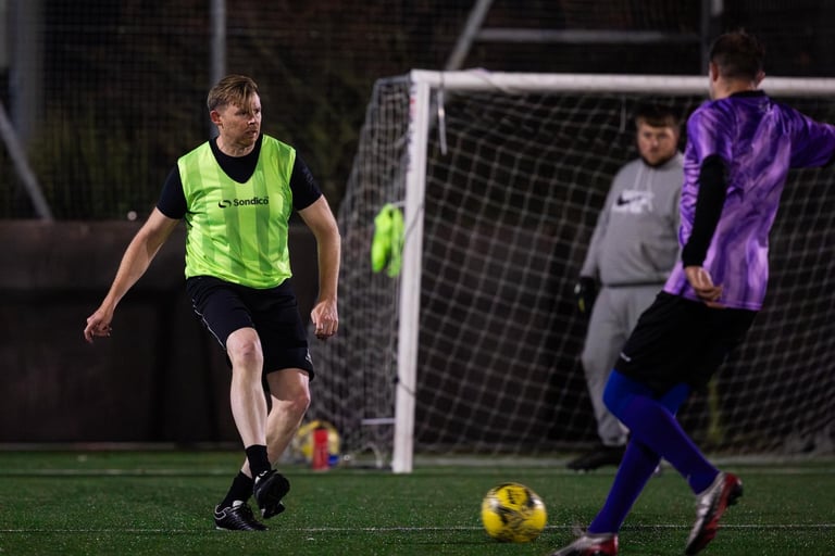 a soccer player is kicking a soccer ball