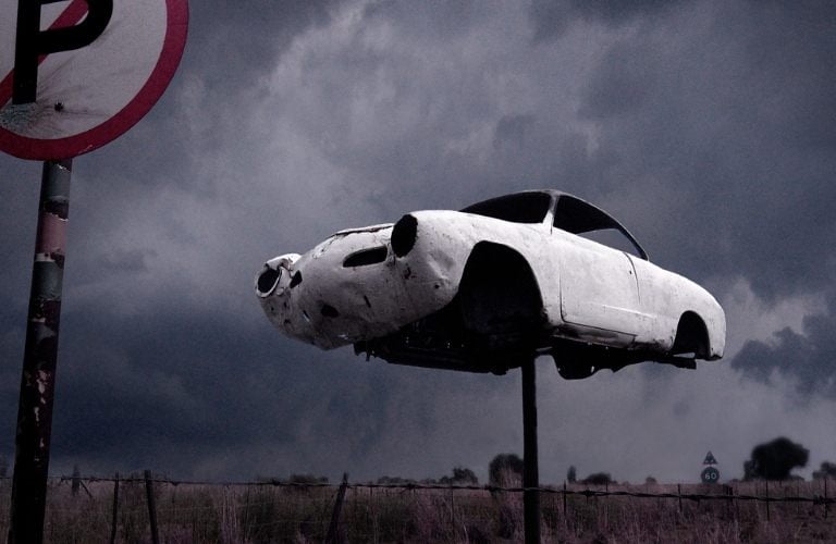 Abandoned fine art photography print from Martin Osner’s iconic collection featuring a vintage car mounted on a pole