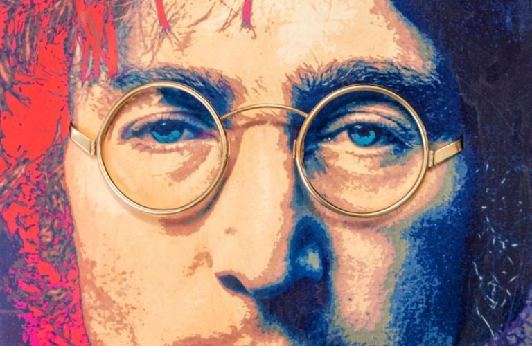Close-up pop art portrait of John Lennon featuring real 18-karat gold-plated round glasses on colorful, painterly background