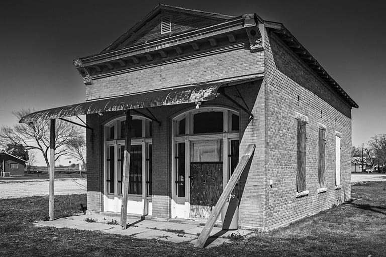 Empty and derelict small brick building in downtowon Weir, TX circa 2013. Perhaps a bank or post office in its day.