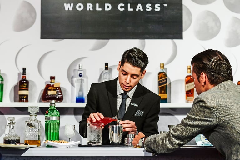 a man in a suit and tie is pouring a drink