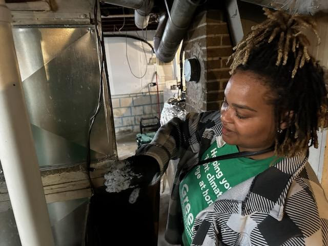 Worker sealing HVAC ducts to save energy