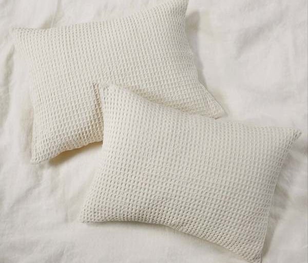 two pillows and a pillow on a bed