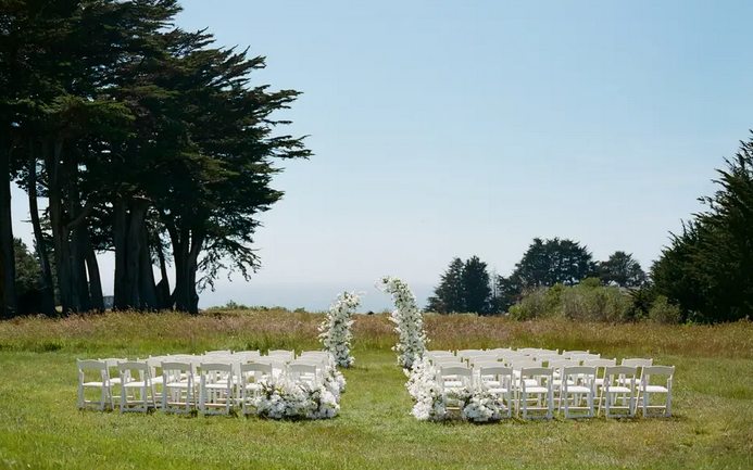 Wedding ceremony on lawn overlooking pacific ocean in Mendocino County