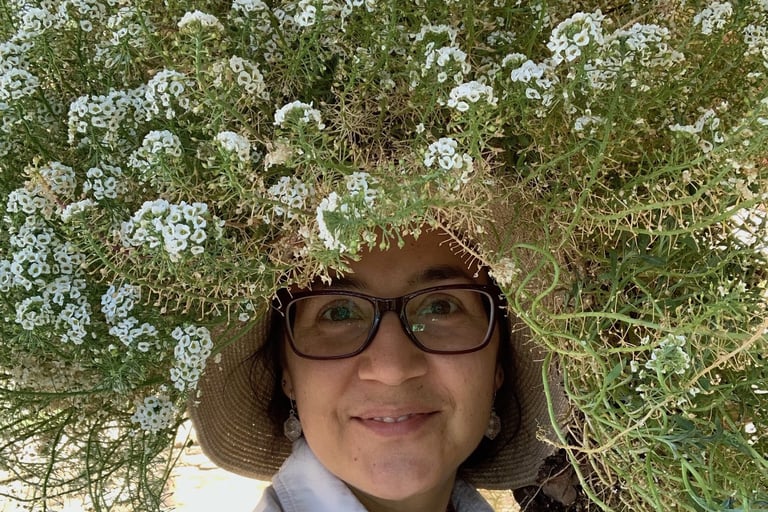 Katrina with a huge spray of alyssum flowers on top of her head