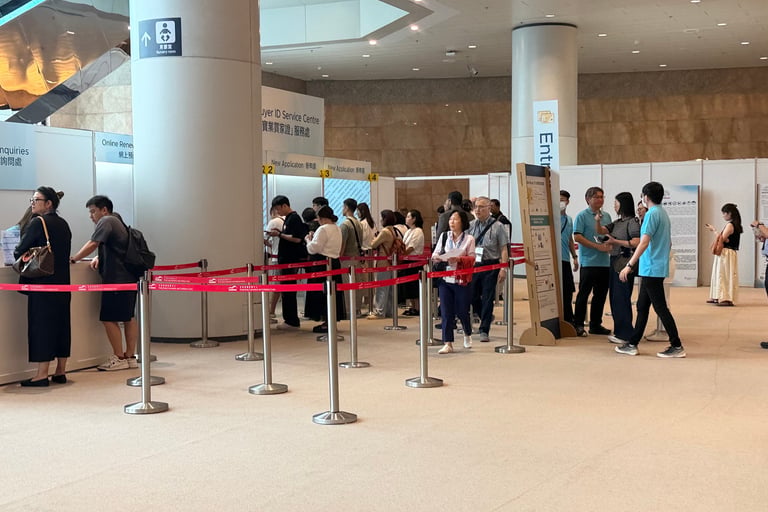 Attendees queuing at onsite registration counters at a Hong Kong jewellery trade show 2026