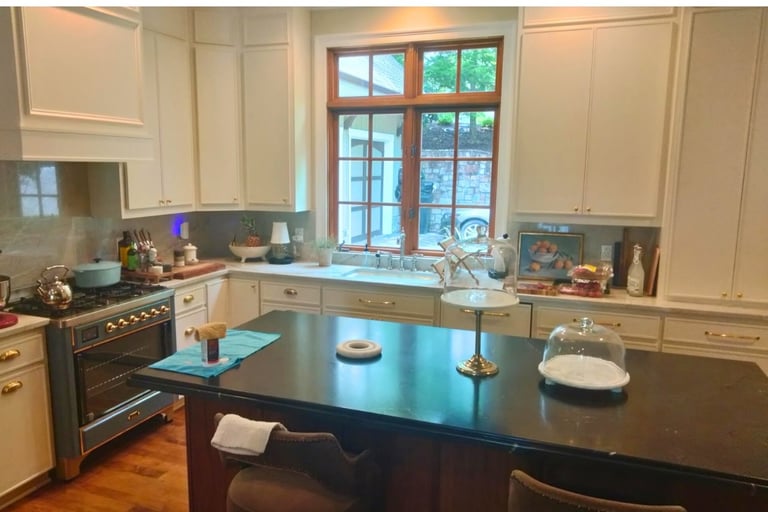 Modern kitchen with black granite island and window over sink