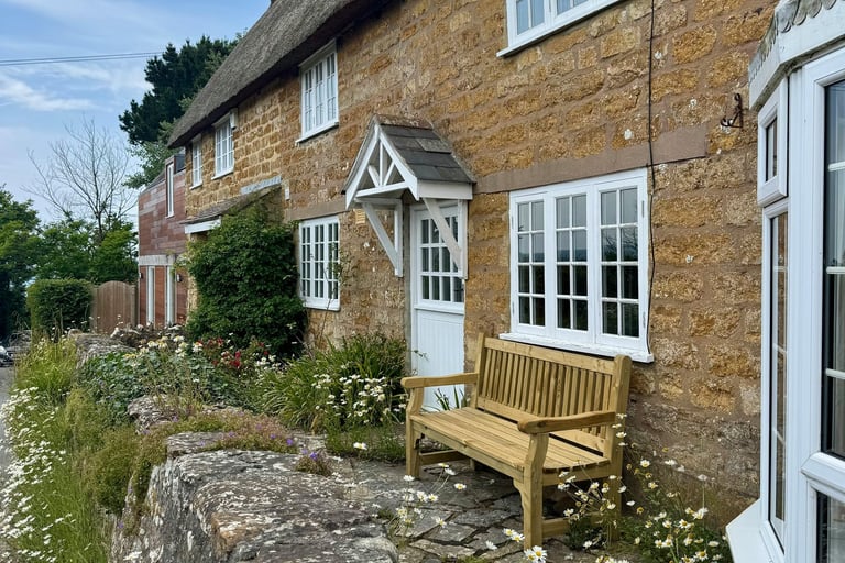 a bench with a bench and a bench in front of a house
