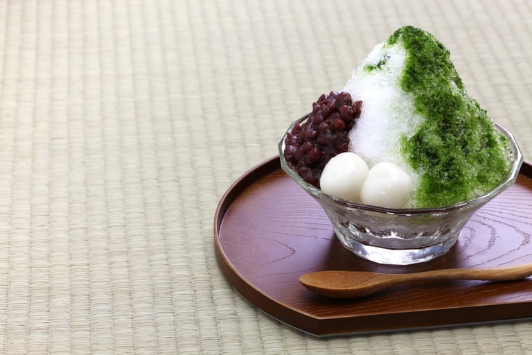 a bowl of shaved ice with matcha and red beans