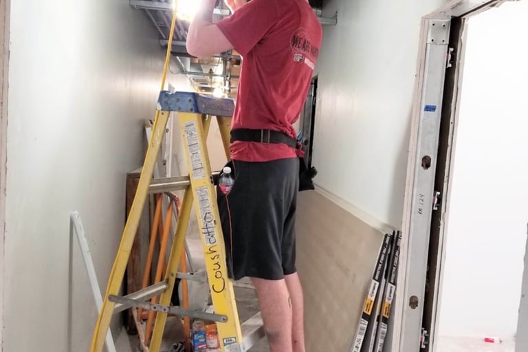 One of our electricians working hard at customer satisfaction!